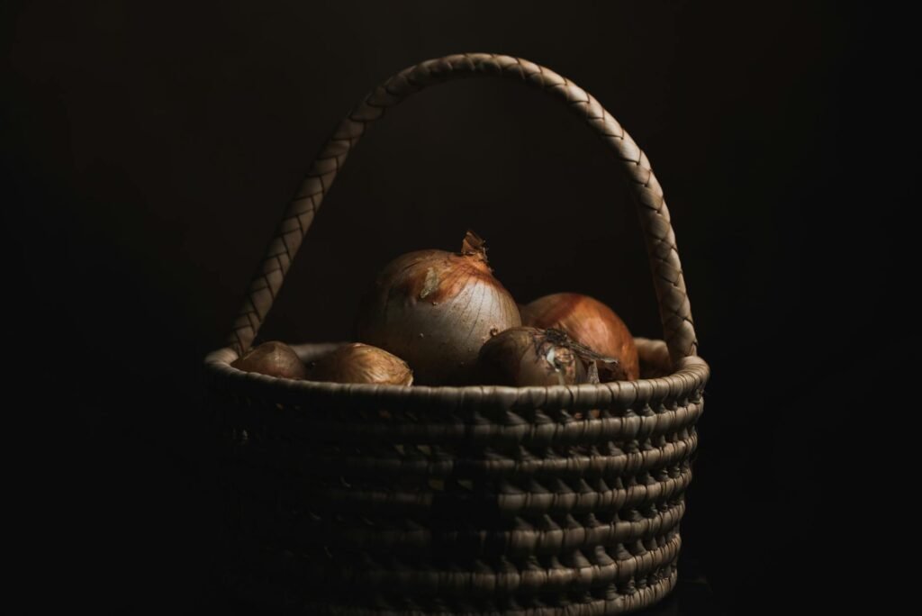 Potatoes stored in a basket in a cool kitchen corner