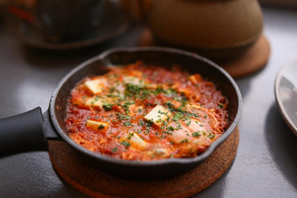 A skillet of crispy browned potatoes with eggs and herbs