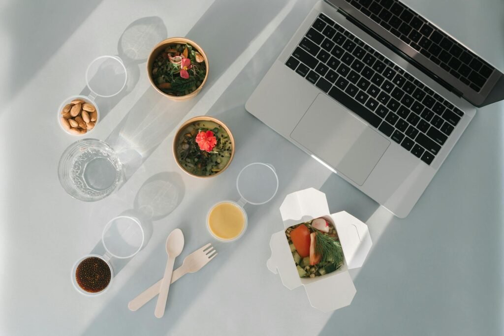 A packed lunch container and insulated lunch bag on a work desk.